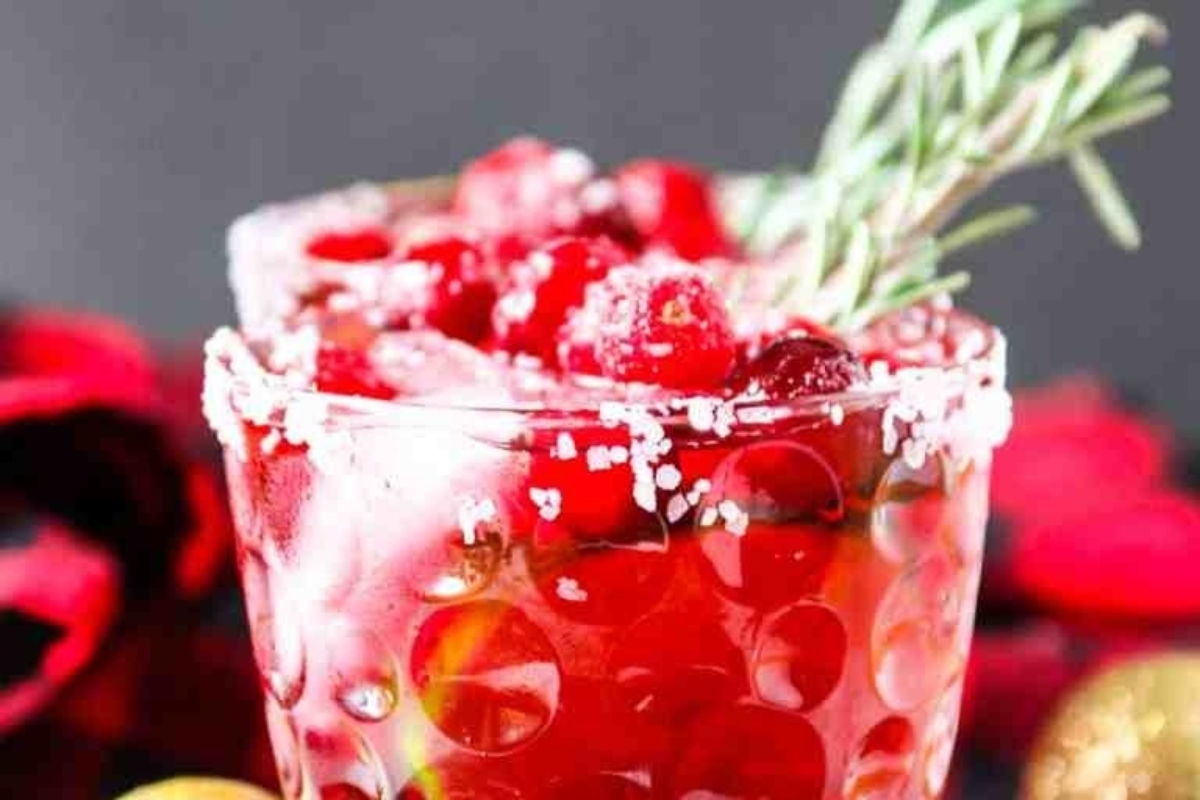 Two glasses of cranberry margarita with rosemary sprigs, perfect for those who love cranberry drinks.
