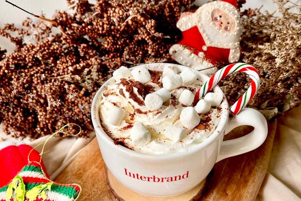 A festive cup of Starbucks holiday hot chocolate adorned with marshmallows and candy canes.