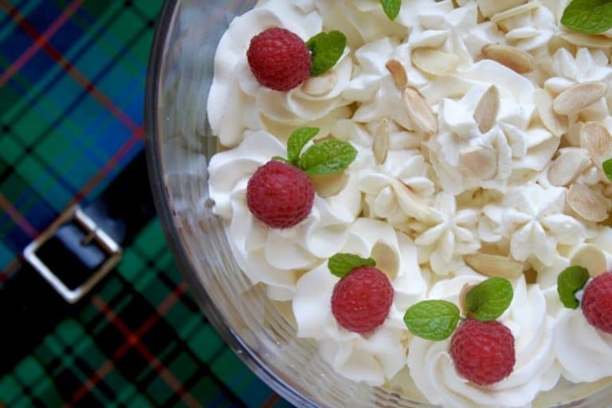 A festive Christmas trifle filled with whipped cream and raspberries.