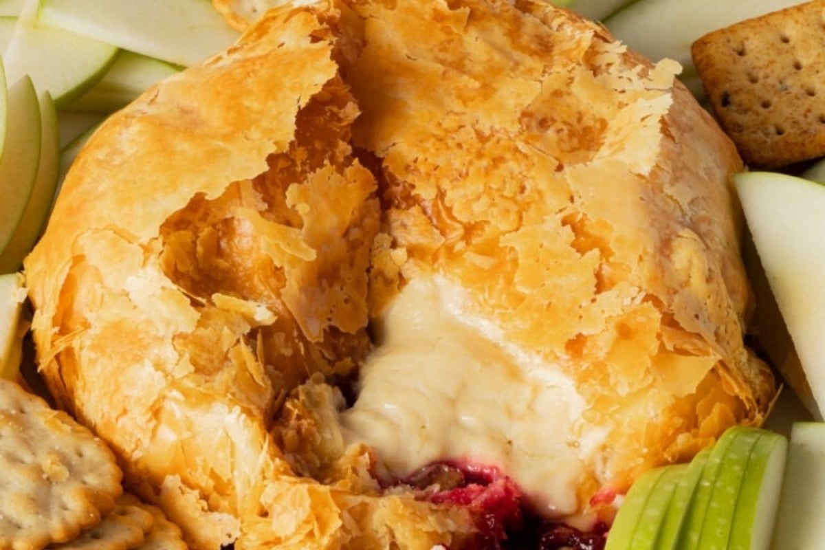 A plate of cranberry crackers and cheese.