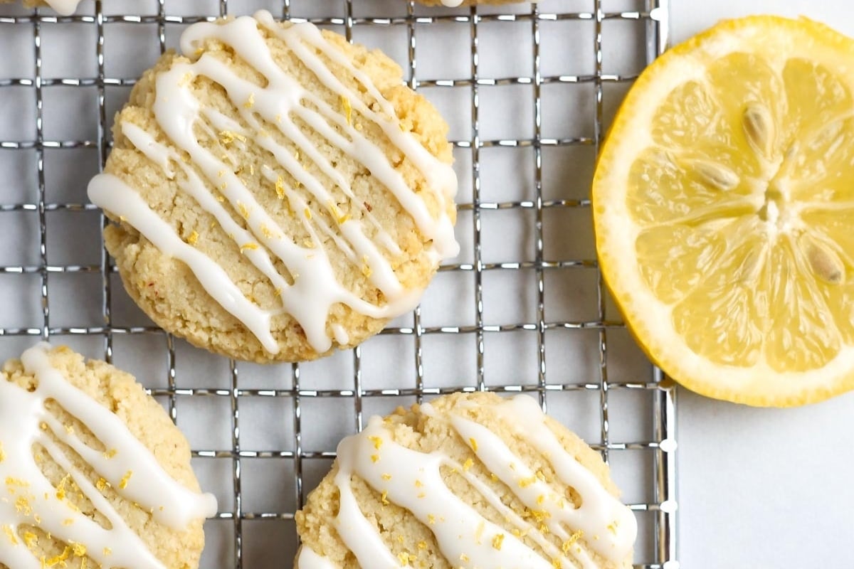 Lemon cookies with icing on a cooling rack, perfect for freezing.