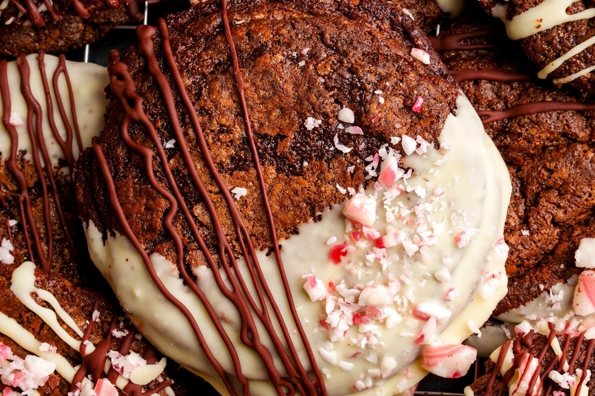 Make ahead chocolate peppermint cookies with white icing and candy canes perfect for the holidays.