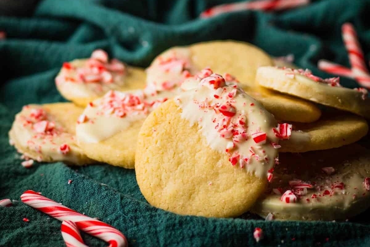 A pile of peppermint cookies adorned with candy canes.