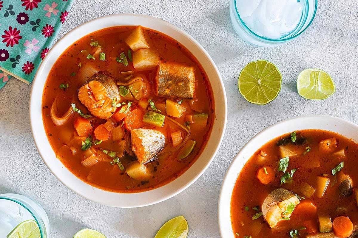 A bountiful feast of two bowls of fish stew on a table, giving a glimpse into the delectable tradition of feast of seven fishes.