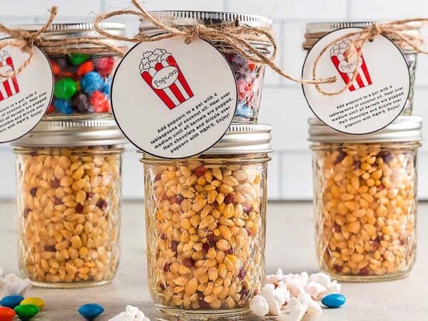 Easy Diy Popcorn Gift Idea: Three jars filled with popcorn and candy.