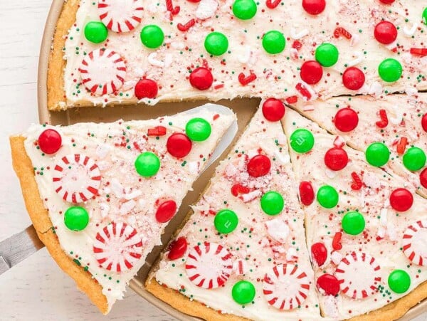 A slice taken from a sugar cookie pizza.