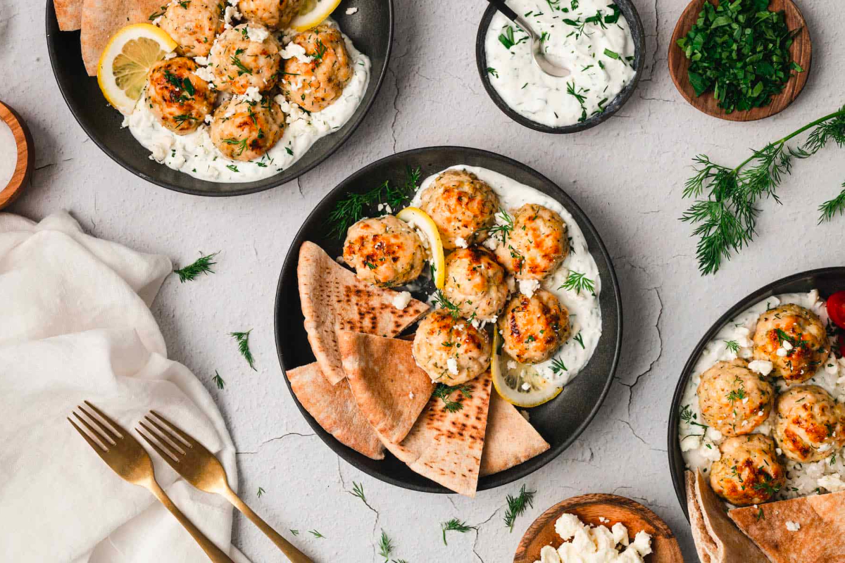 Delicious gyro meatballs with tzatziki sauce and pita bread, perfect for your New Year's Eve party.