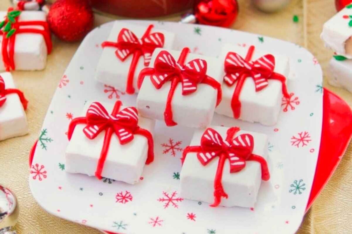 A plate of white marshmallows with red and white ribbons.