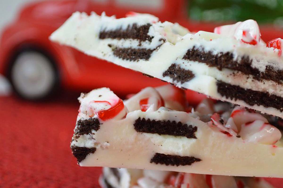 A stack of white chocolate and peppermint candy bars on top of a red truck, perfect for Christmas bark recipes!