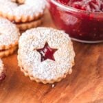 A group of jam-filled star-shaped Linzer cookies.