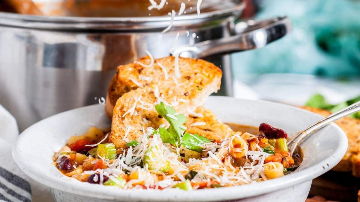 A bowl of soup with bread in it.