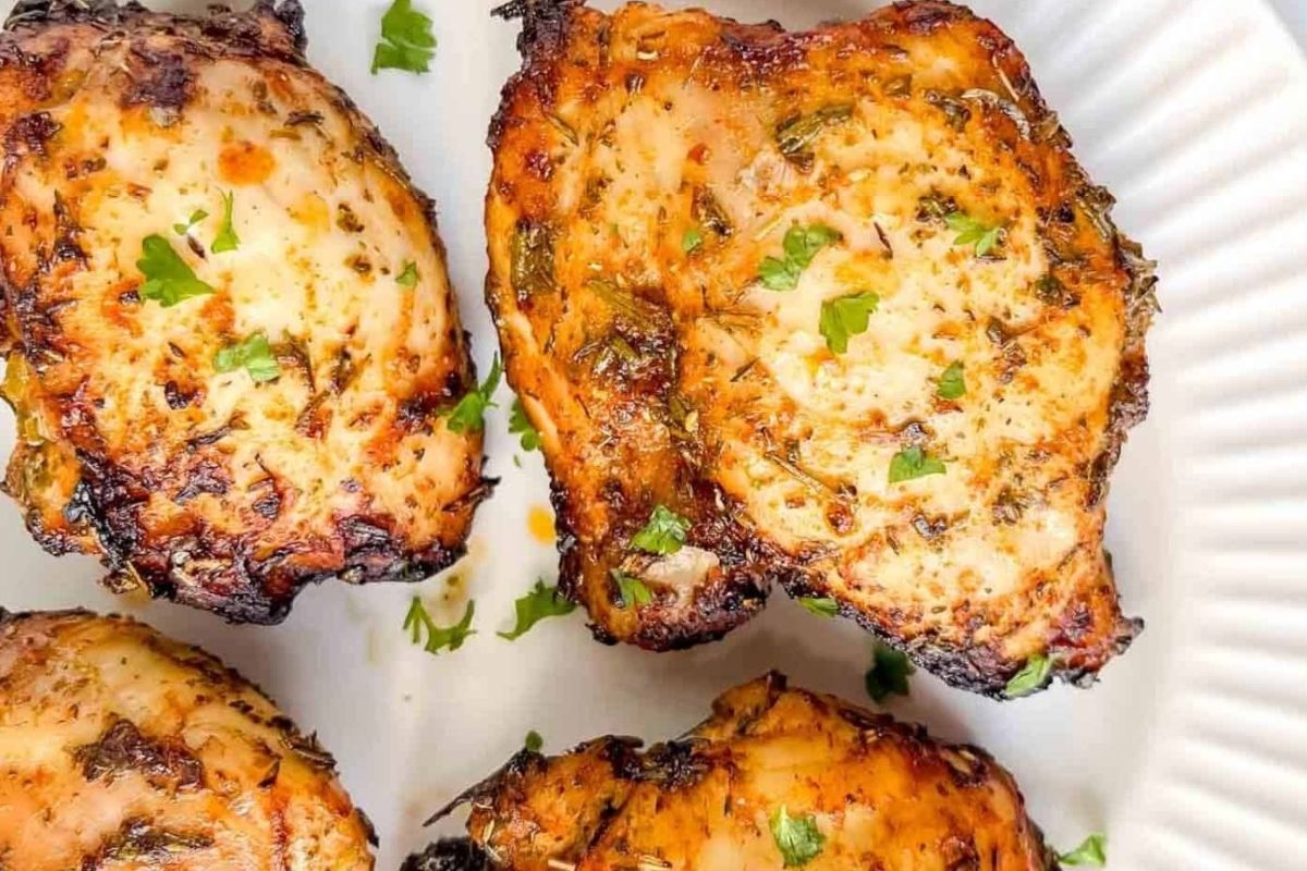 Wholesome grilled chicken breasts on a white plate.
