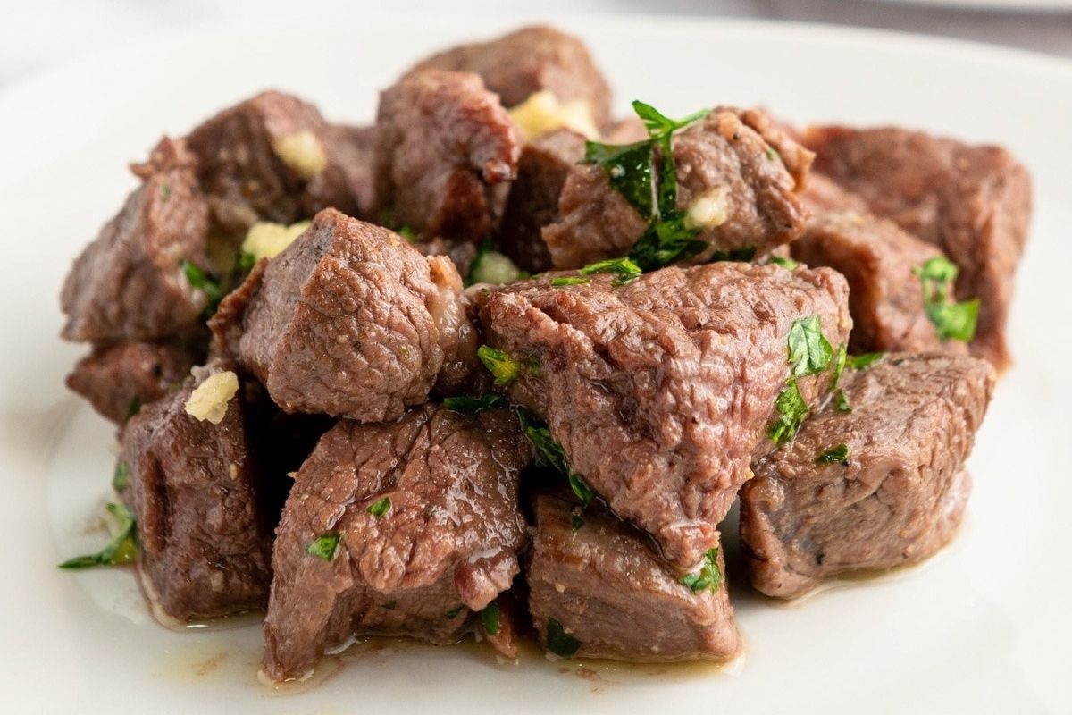 A wholesome plate of beef with fresh herbs, cooked to perfection in an air fryer.