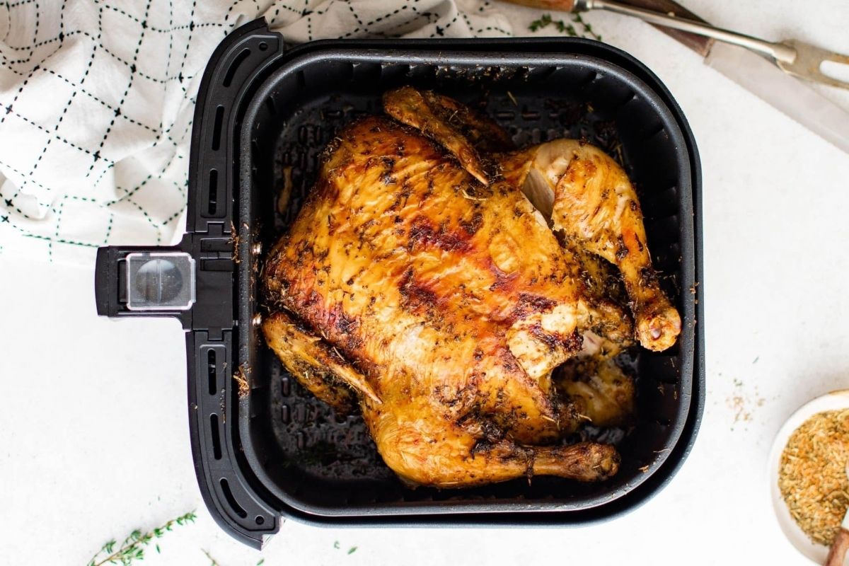 A wholesome roasted chicken cooked in an air fryer.