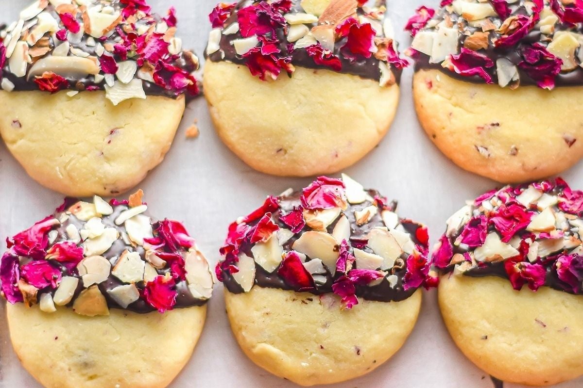 A tray of Valentine's desserts covered in chocolate and roses.