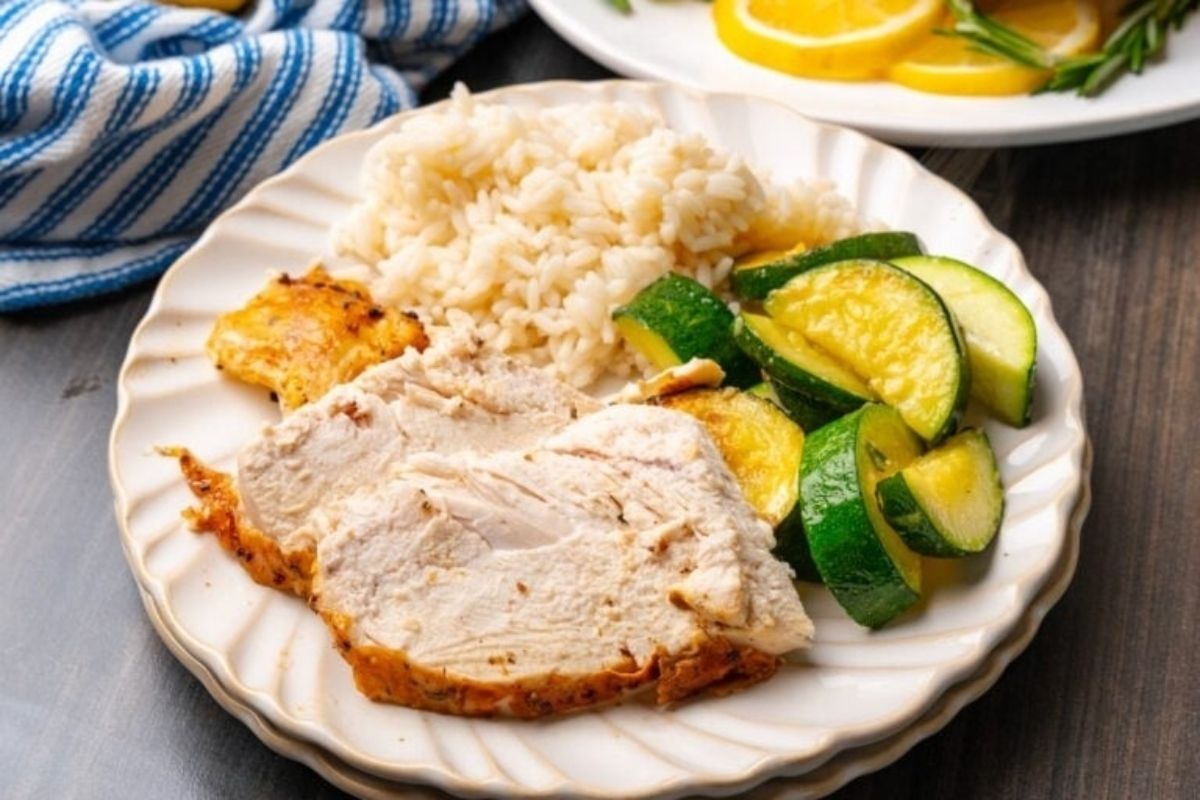 A wholesome plate with chicken, rice and vegetables on it.