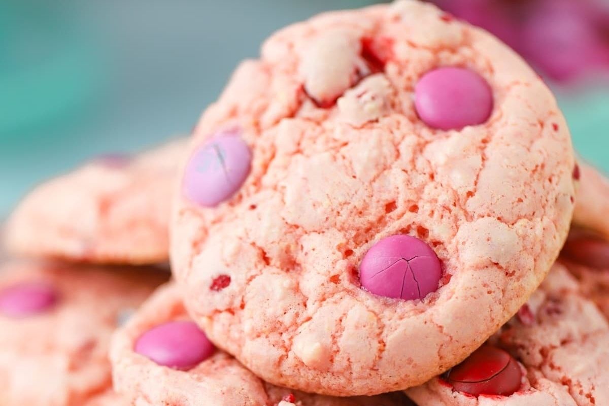 A pile of pink cookies with pink sprinkles on top, perfect for those craving a sweet treat with a touch of girlish charm.