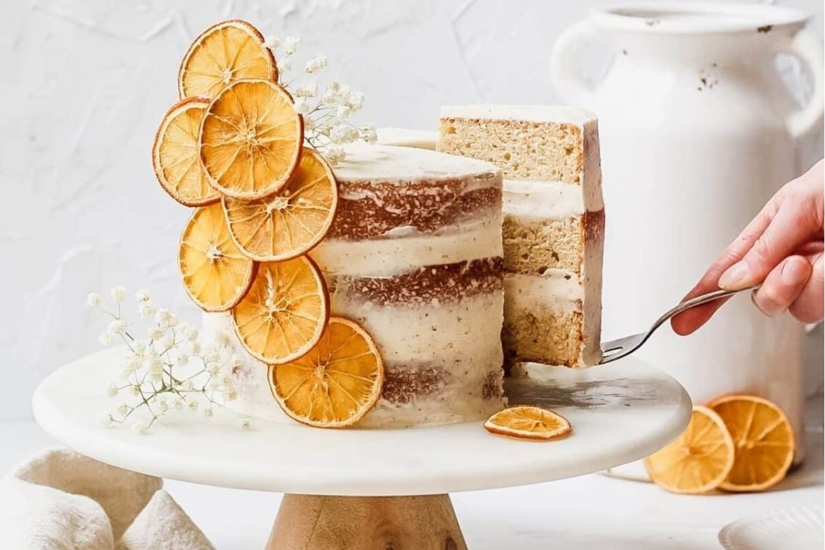 A slice of cake topped with fresh orange slices.