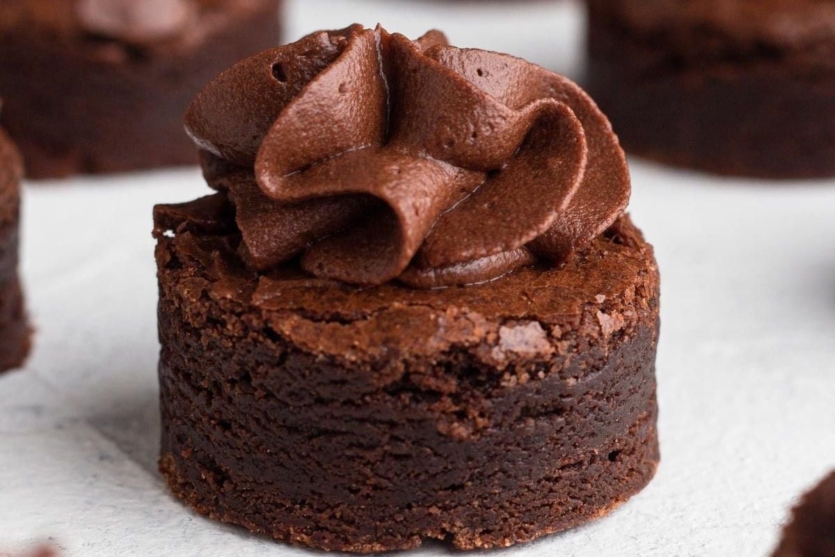 A close up of chocolate cupcakes with frosting that could satisfy your cravings for brownie recipes.