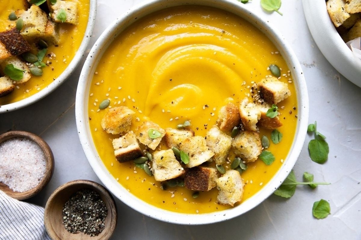         Description: Two bowls of wholesome soup with croutons made in a slow cooker.
