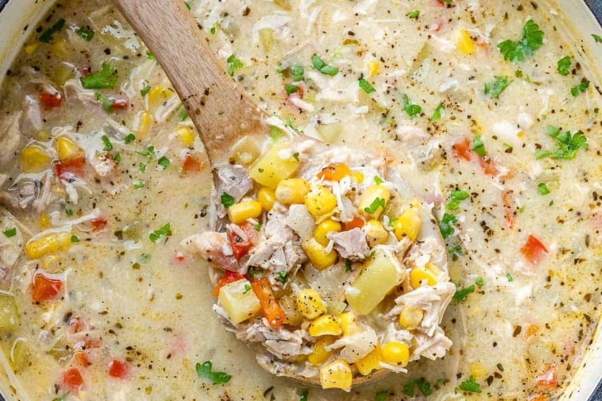 Chicken corn chowder with a wooden spoon - perfect for your chowder recipe collection!