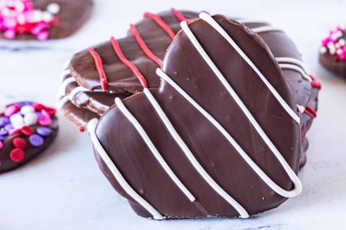 Heart-shaped chocolate cookies with sprinkles and icing.