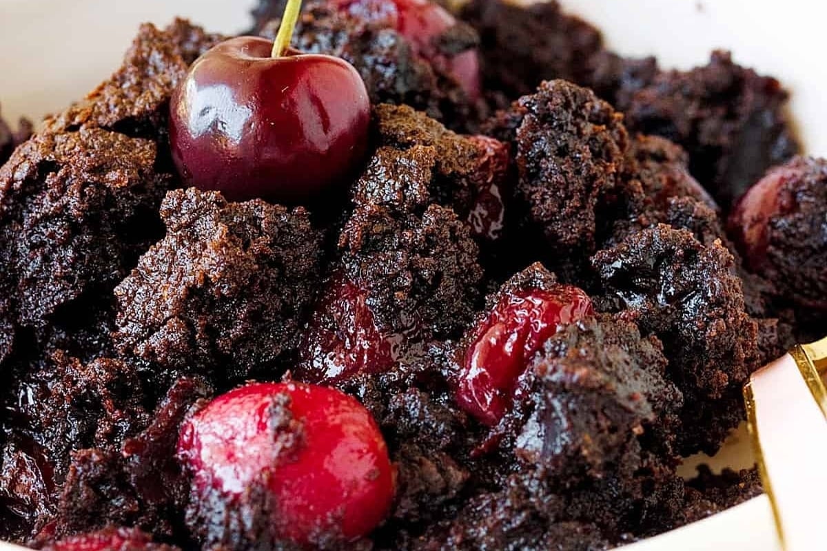 A bowl of dump cakes with cherries in it.