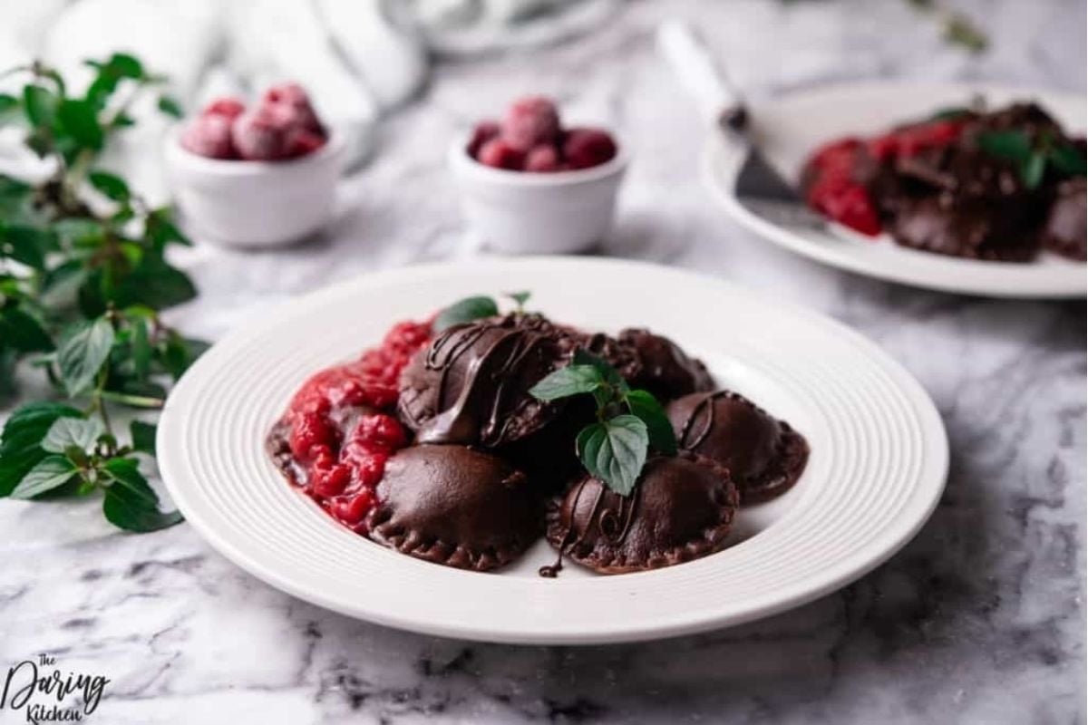 Delicious chocolate truffles with cranberries displayed on a white plate.