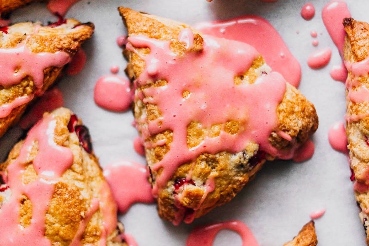 Pink recipes: Scones with pink icing on a baking sheet.