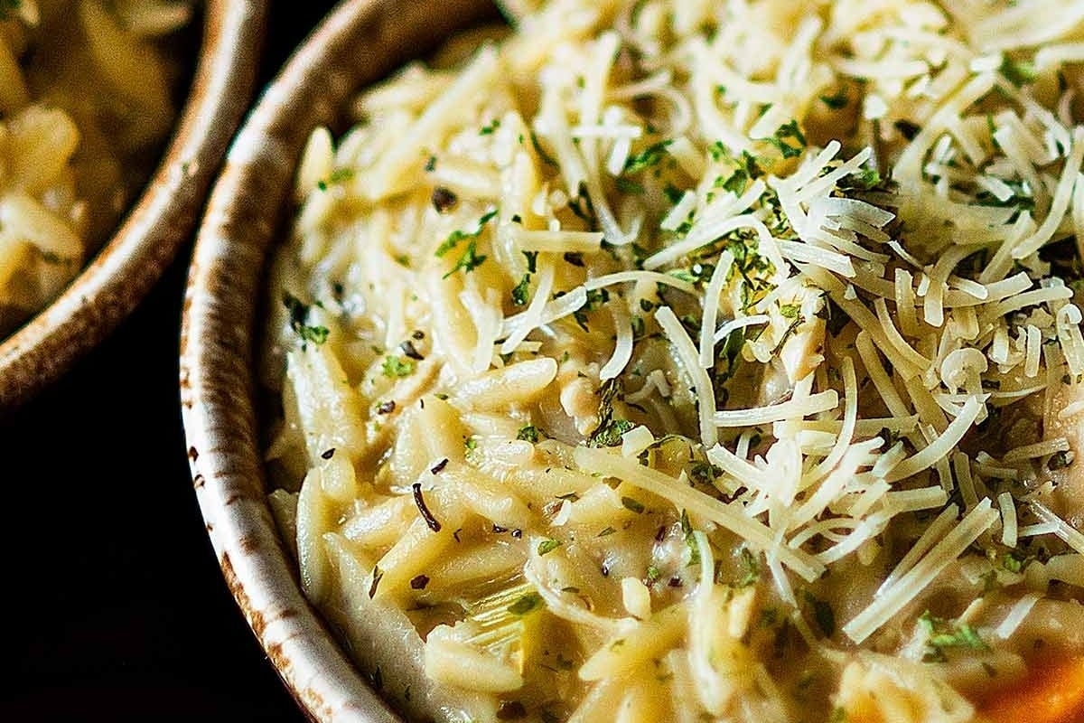 Two bowls of creamy pasta with cheese and parmesan.