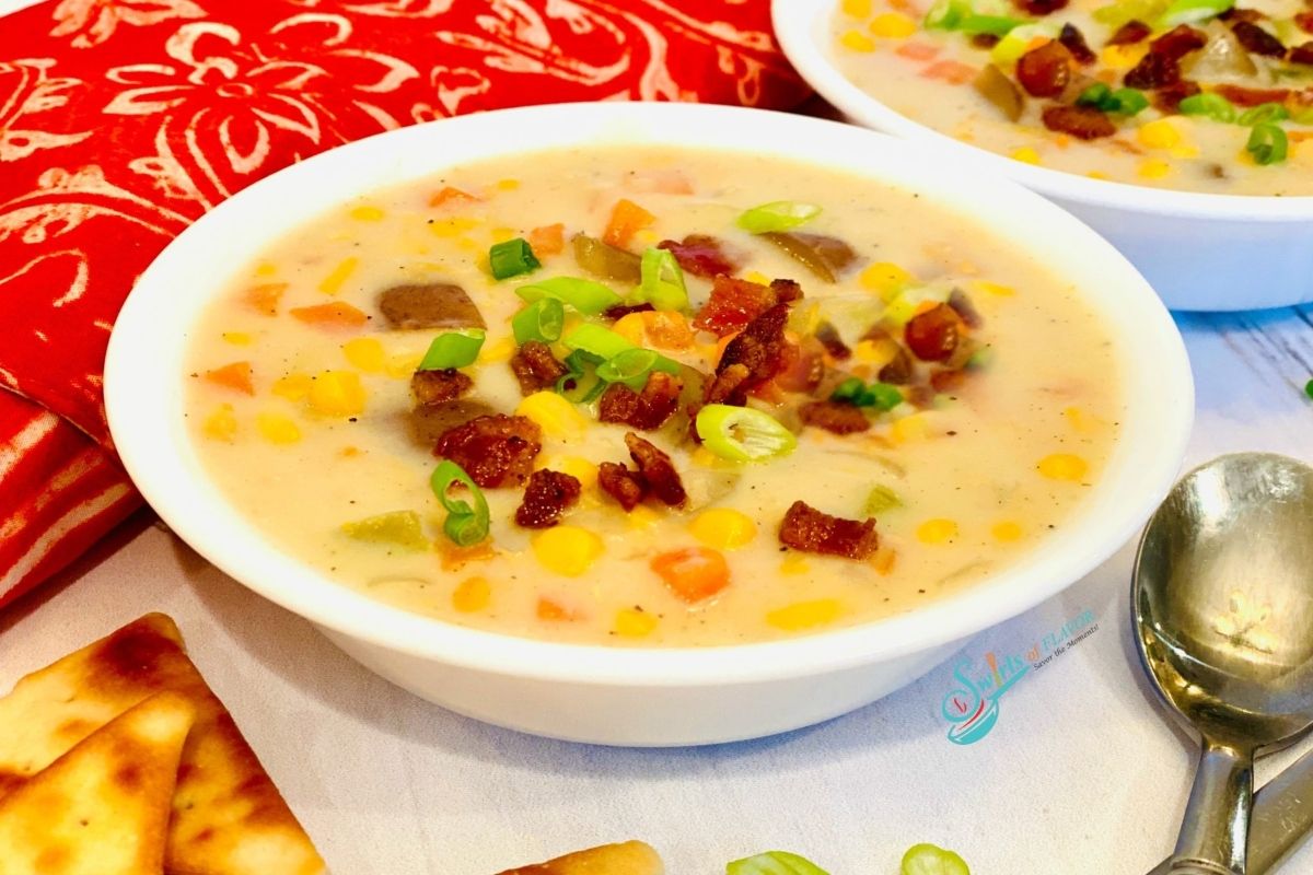 Delicious corn chowder served with crackers.