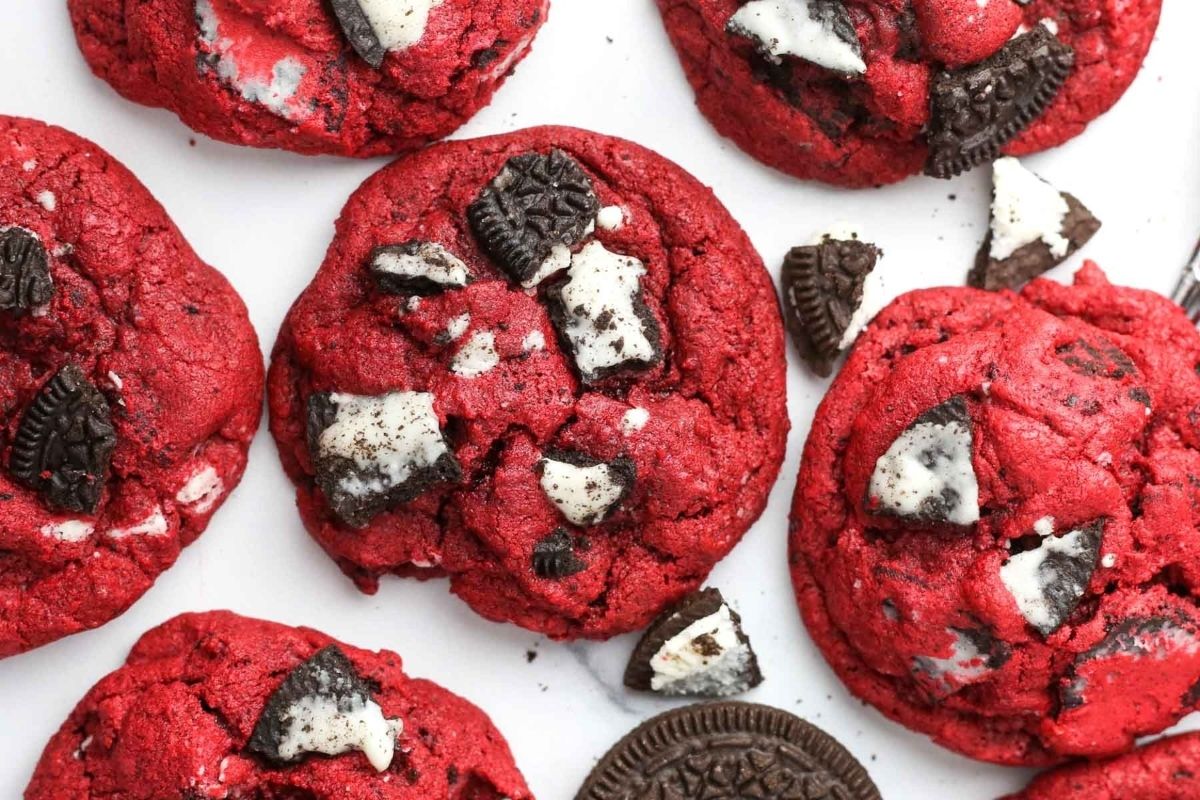 Red velvet cookies with chunks of chocolate sandwich cookies, perfect as Valentine’s Day cookies, displayed on a white surface.