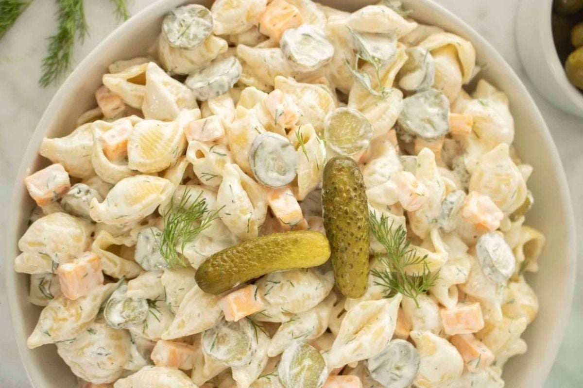 A bowl of pasta salad with cucumbers and pickles, perfect for pickle lovers.