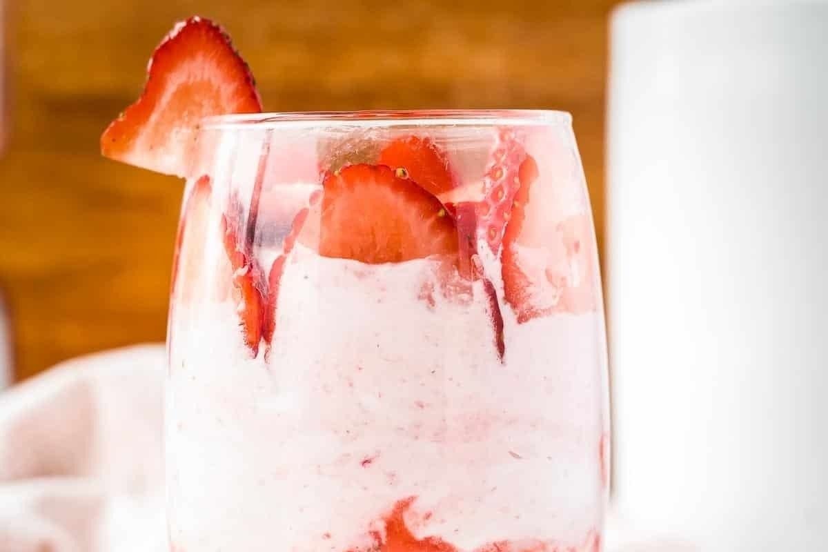 Pink strawberry ice cream in a glass.