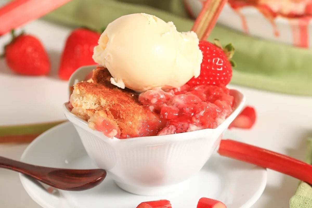 Rhubarb cobbler with ice cream and strawberries, a delicious twist on classic dump cakes.