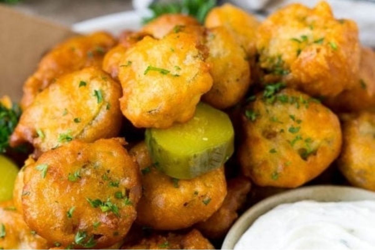 Delicious pickle recipes featuring fried pickles and dip on a plate.