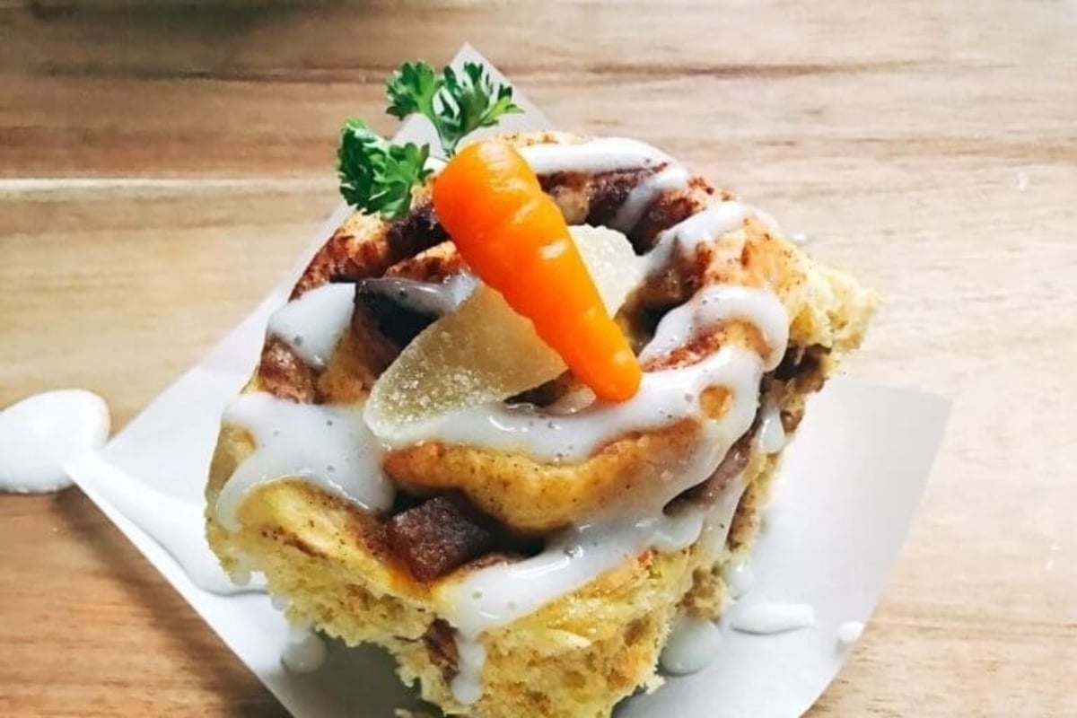 A delicious cinnamon roll recipe with a twist - we've added fresh carrots to the dough and topped it off with a generous drizzle of creamy icing. Indulge in this mouthwatering