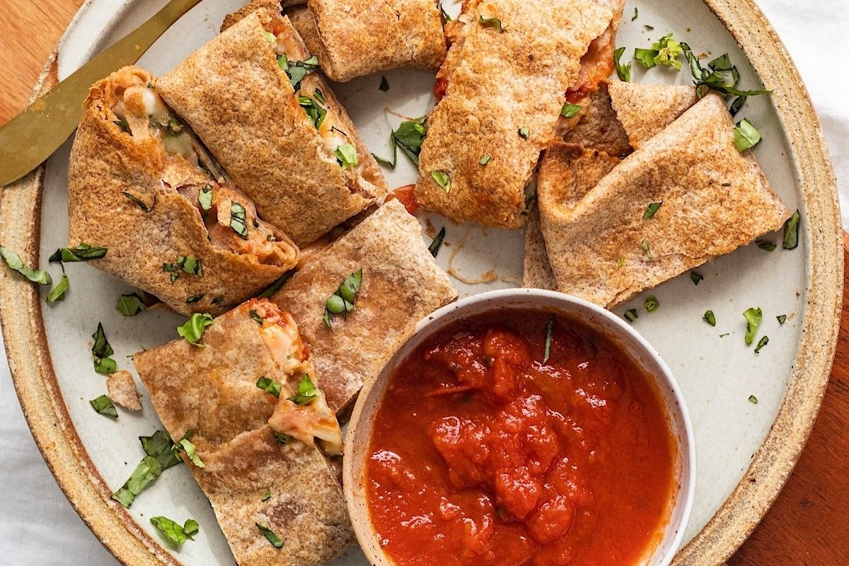 A plate with wholesome tortillas and sauce on it.