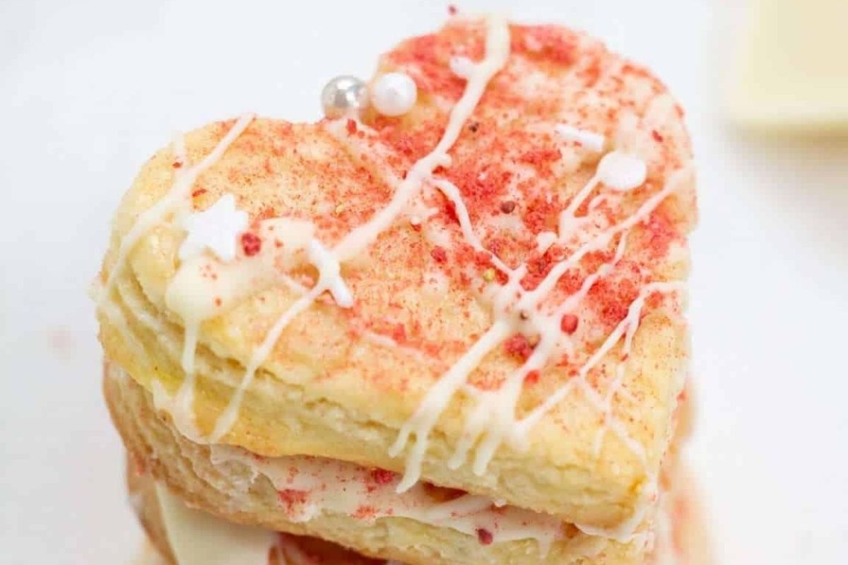 A stack of heart shaped cookies on a white plate, perfect for Valentine's desserts.