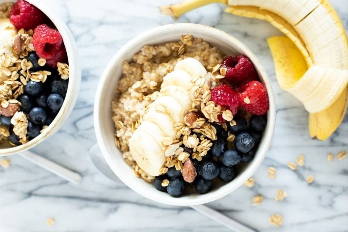 Two bowls of winter oatmeal with berries and bananas made in an Instant Pot.