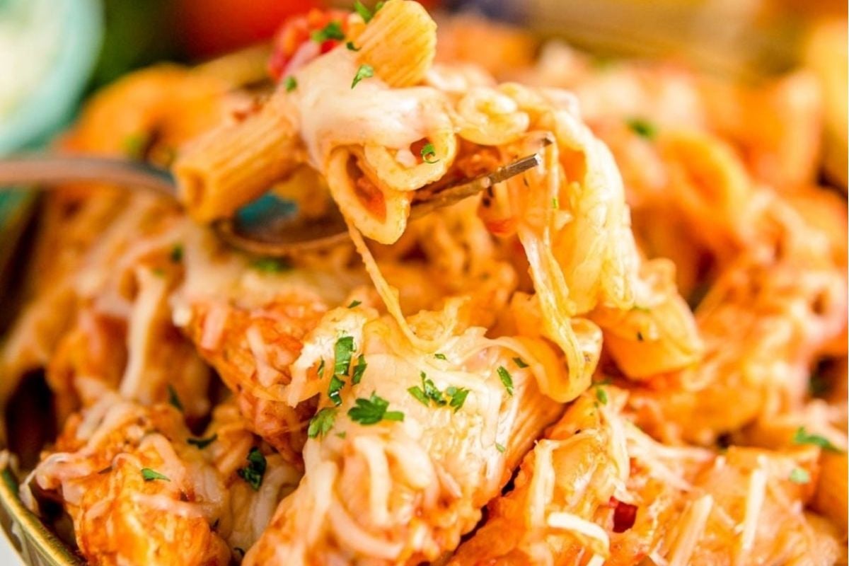 In the midst of winter, a fork delicately pierces through a steaming plate of Instant Pot chicken pasta before taking a mouthwatering bite.