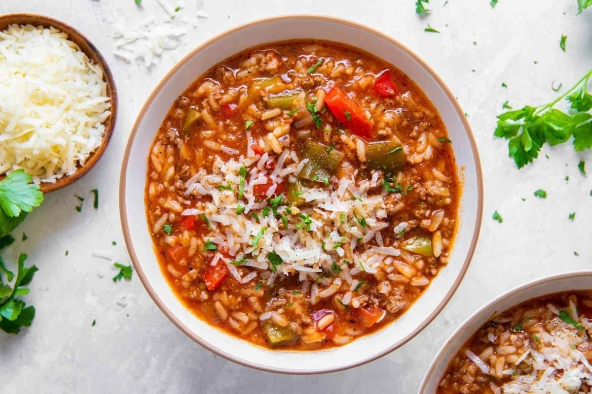 A warm winter bowl of beef and rice soup with peppers, cooked perfectly in an Instant Pot. The dish is garnished with a sprinkle of parmesan, adding a touch of savory goodness