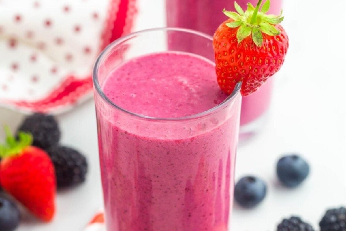Two glasses of smoothie with berries, blackberries, and pinwheel recipes.