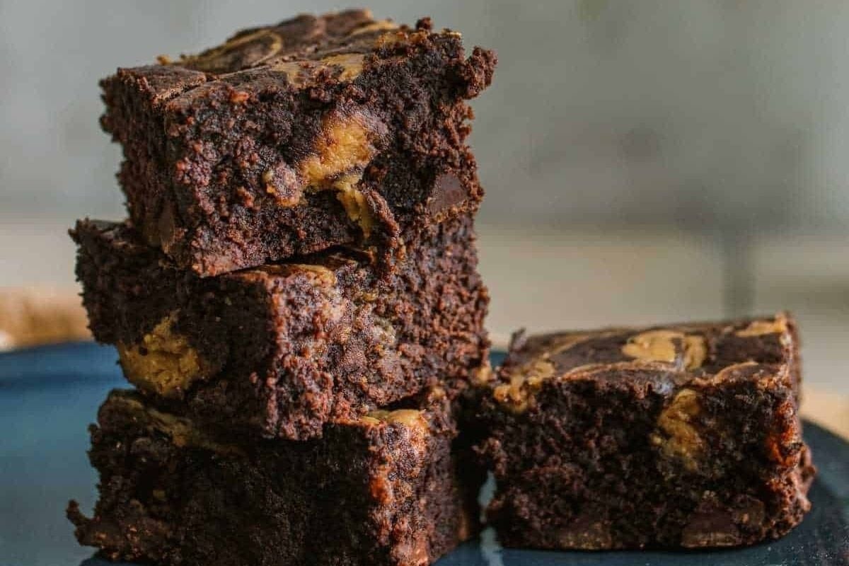 A stack of chocolate brownies on a blue plate, perfect for indulging in delicious homemade brownies.