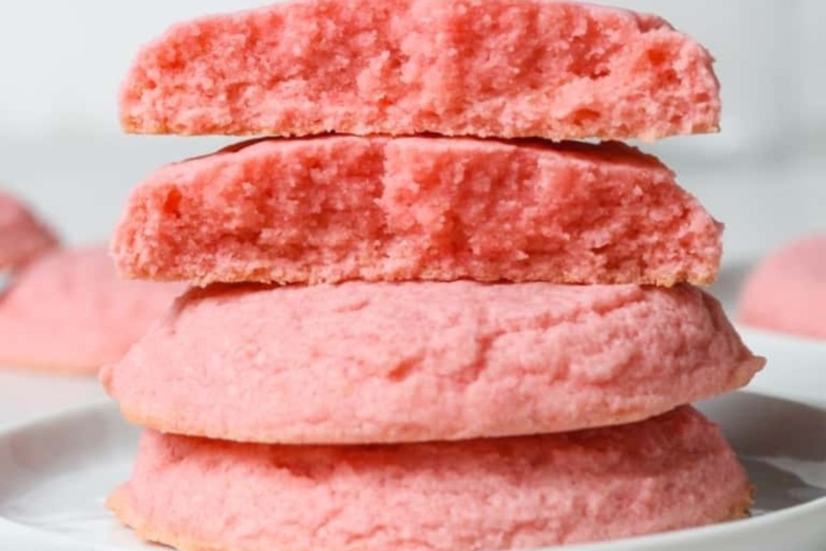 A stack of pink cookies on a plate, perfect for those who love all things pink. These cookies are not only visually appealing but also delightfully delicious, making them an ideal treat for any