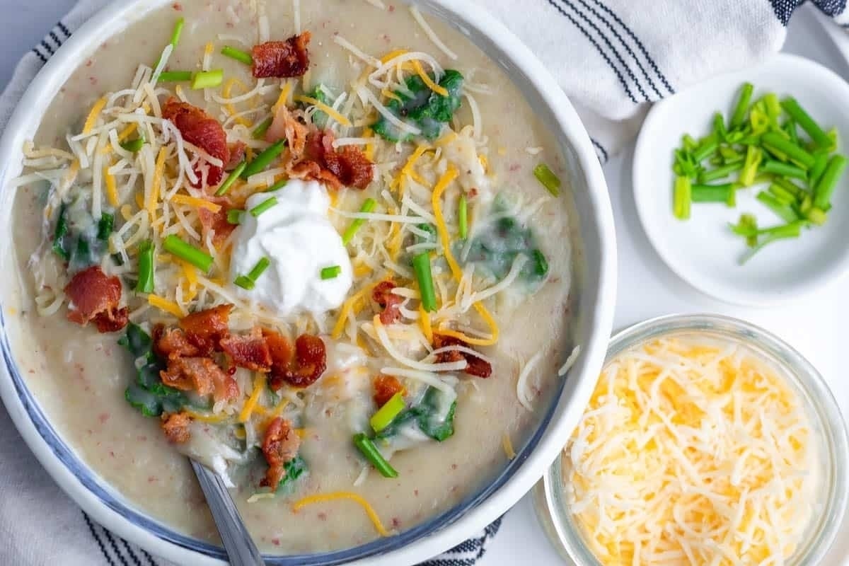 A creamy bowl of potato soup with bacon and sour cream.