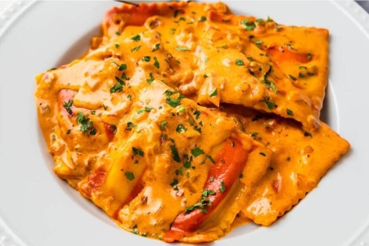 Delicious cheesy ravioli on a white plate.