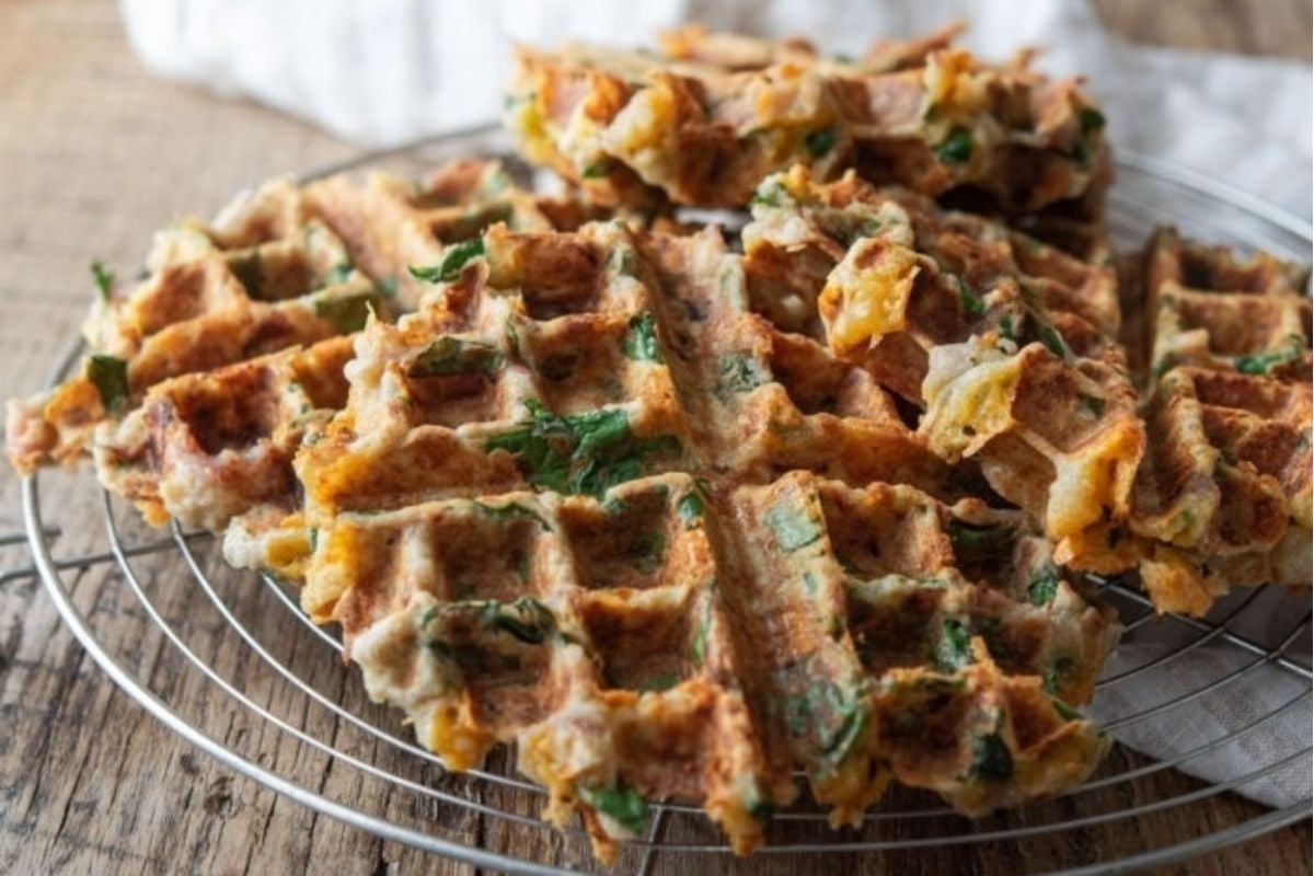 Delicious waffles with spinach and cheese cooked to perfection on a wire rack.