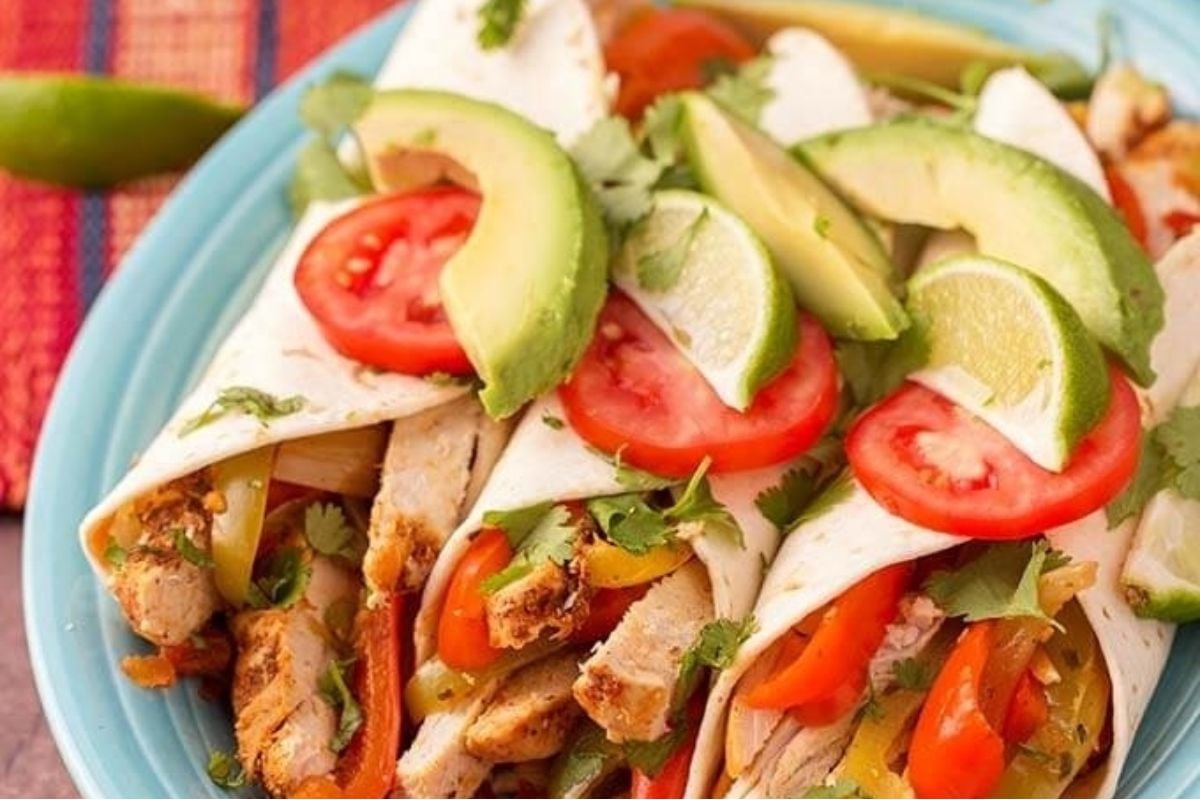 Wholesome Mexican chicken burritos on a blue plate.
