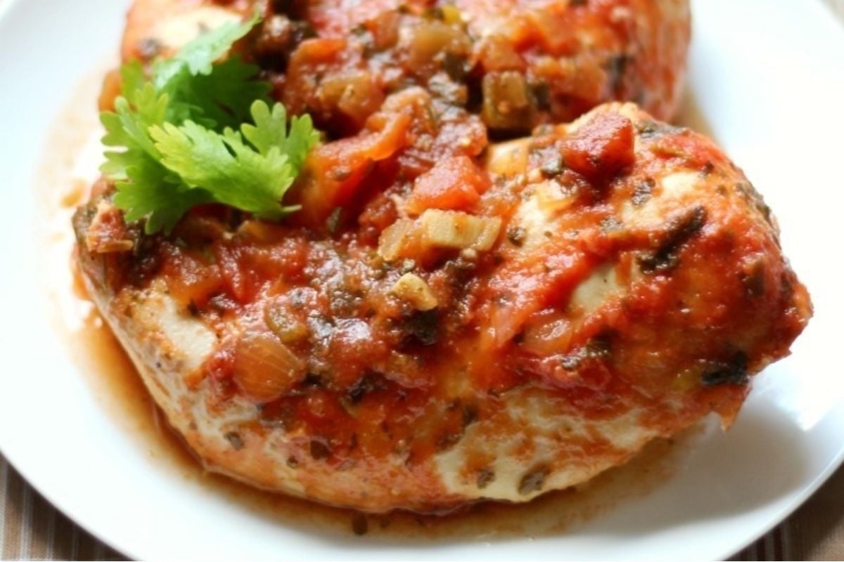 Wholesome chicken breasts with tomato sauce on a plate.